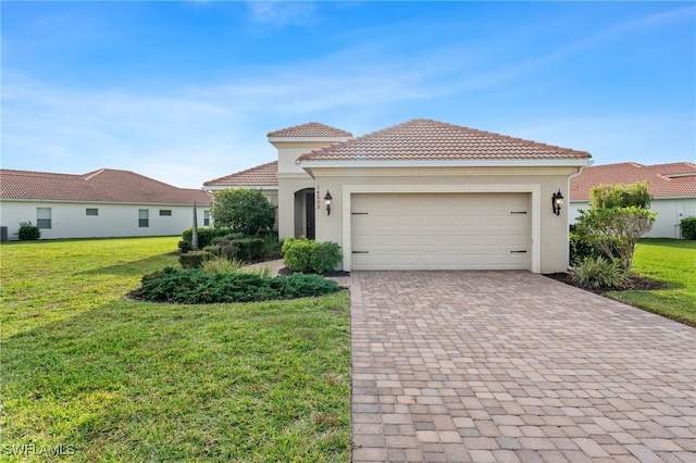 mediterranean / spanish-style home featuring a garage, decorative driveway, a front yard, and stucco siding