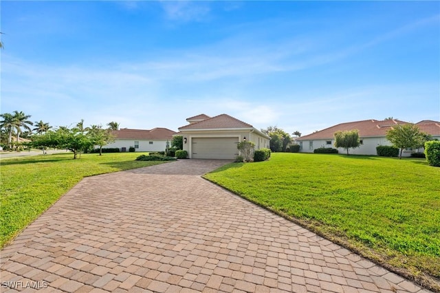 view of front of house with a front yard, decorative driveway, and an attached garage