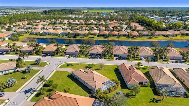 drone / aerial view featuring a water view and a residential view