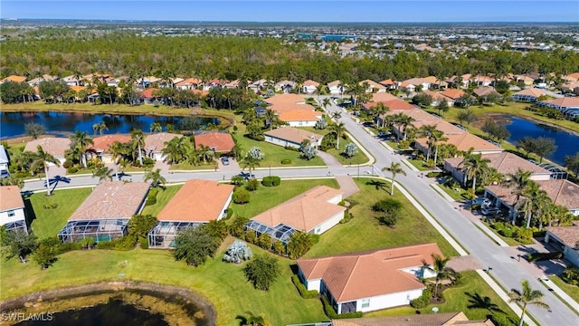 birds eye view of property with a water view and a residential view