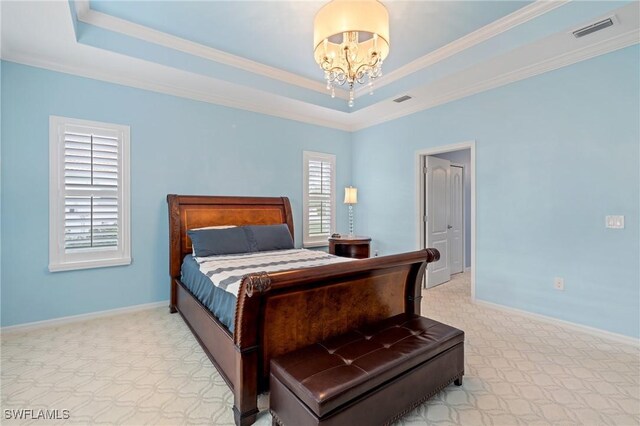 carpeted bedroom with a raised ceiling, a notable chandelier, and crown molding