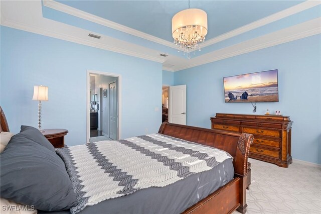 bedroom with a notable chandelier, connected bathroom, ornamental molding, and a tray ceiling