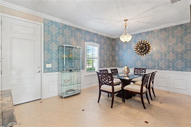 dining space featuring ornamental molding and light tile patterned floors