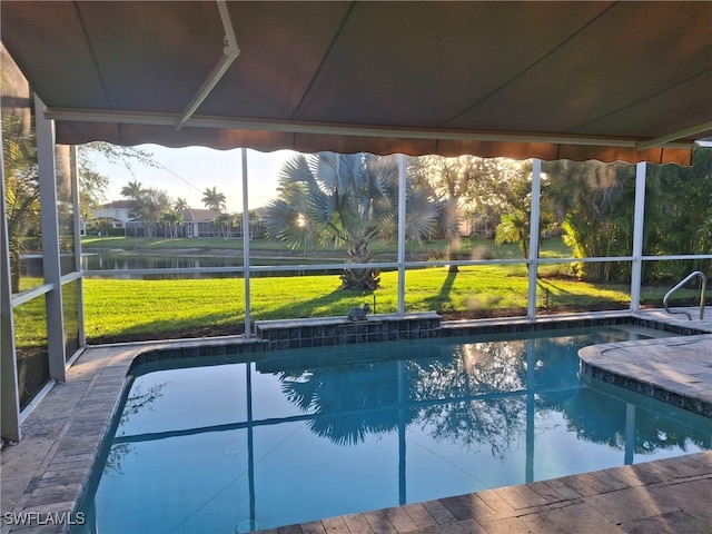 pool with a yard and a water view