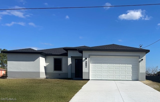 view of front of property with a front yard and a garage