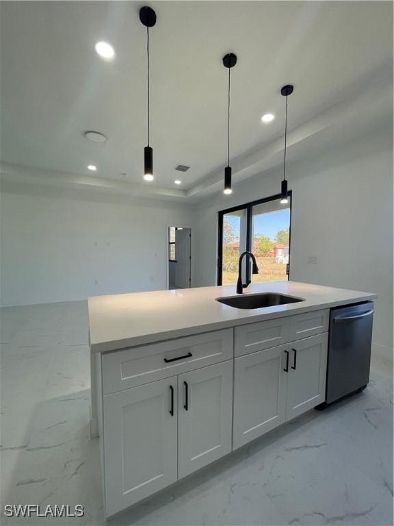 kitchen featuring white cabinetry, sink, stainless steel dishwasher, decorative light fixtures, and a tray ceiling