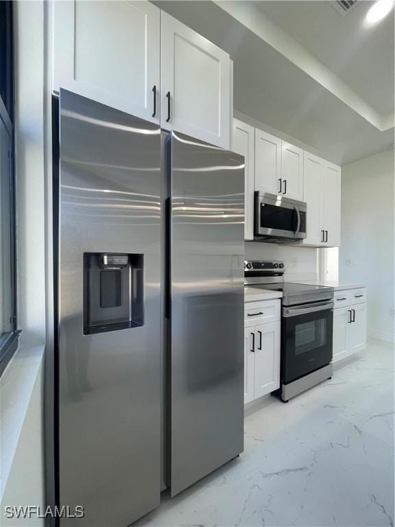 kitchen featuring white cabinets and appliances with stainless steel finishes