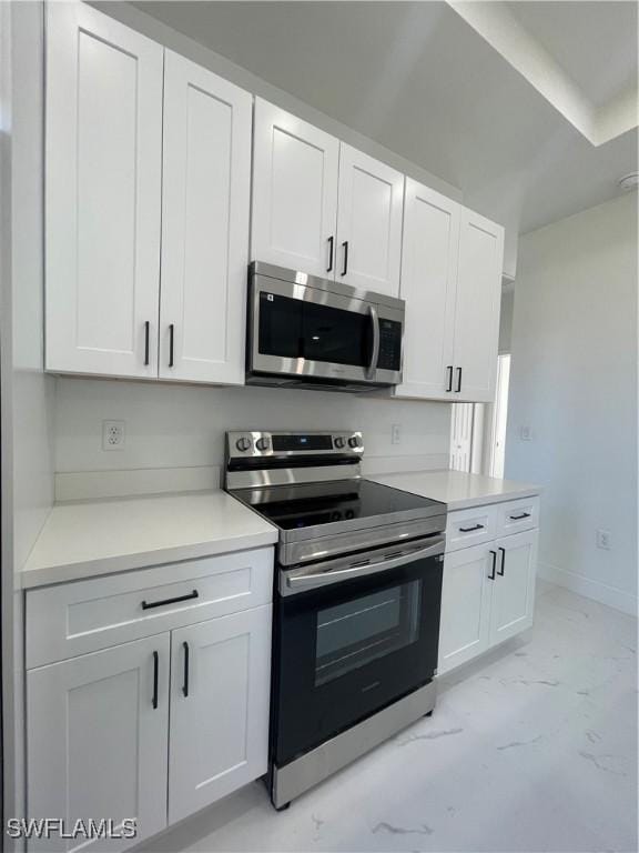 kitchen with stainless steel appliances and white cabinetry