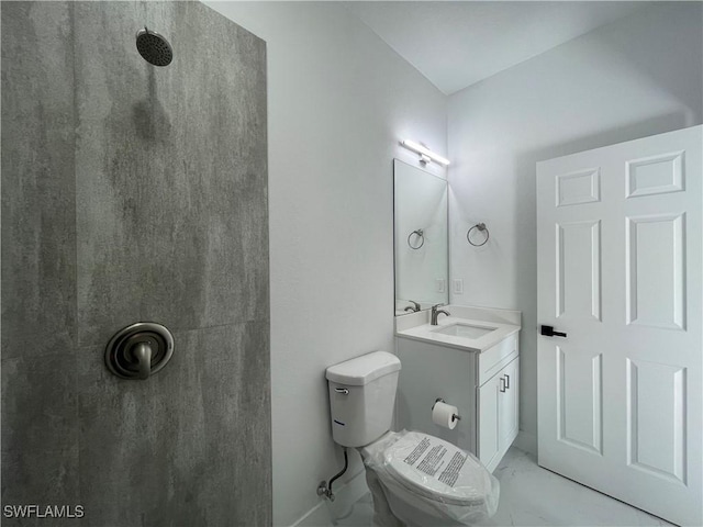 bathroom with vanity, toilet, and a shower