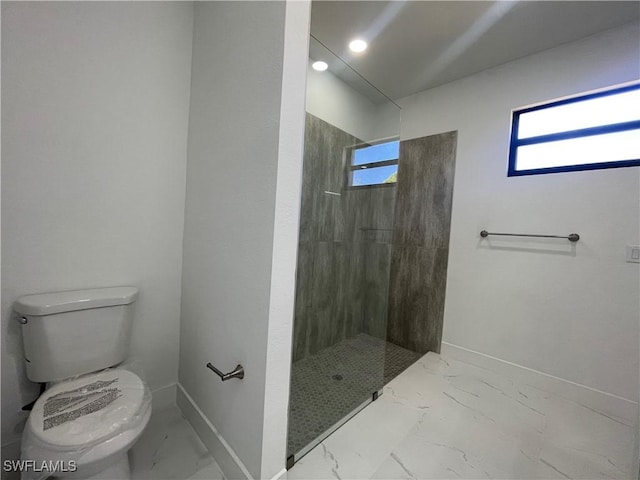 bathroom featuring toilet and walk in shower