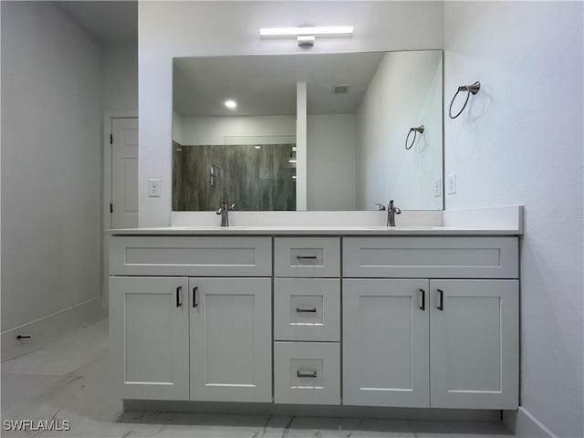 bathroom with vanity and a shower