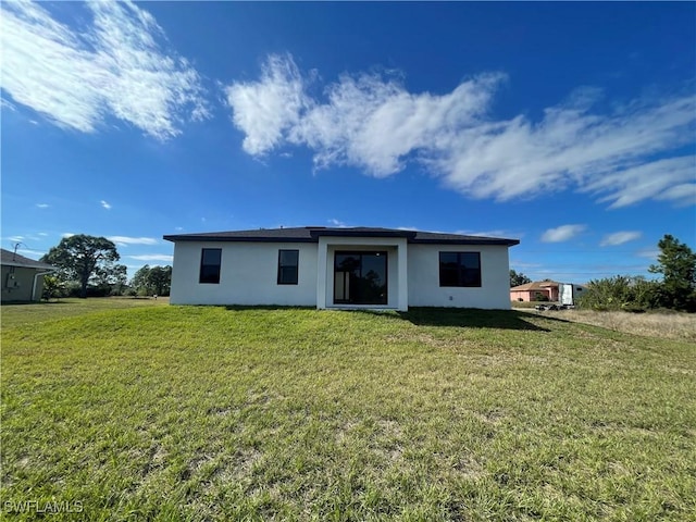 back of house featuring a lawn