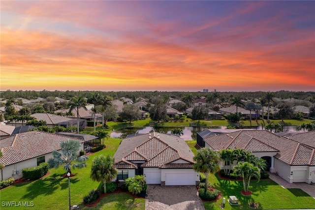 aerial view at dusk with a water view