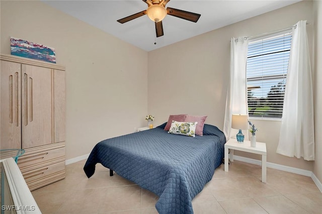 bedroom with ceiling fan and light tile patterned floors