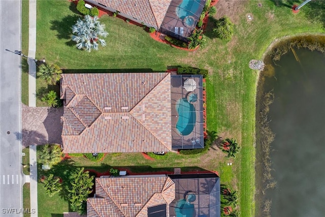 birds eye view of property with a water view