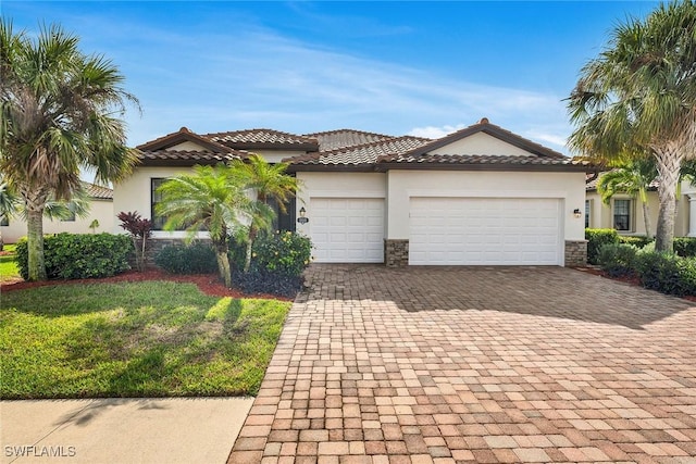 mediterranean / spanish-style house with a front lawn and a garage