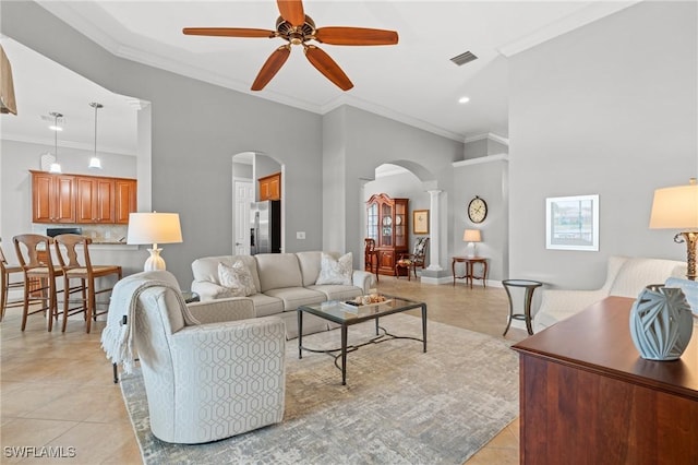 tiled living room featuring ceiling fan and crown molding