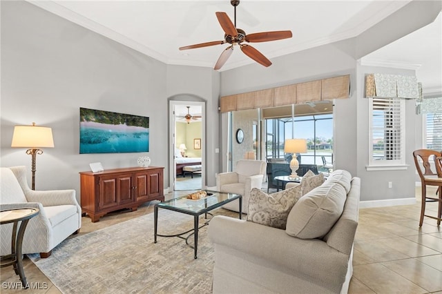 tiled living room with ceiling fan and ornamental molding