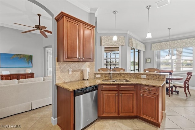 kitchen with decorative light fixtures, ceiling fan, dishwasher, decorative backsplash, and sink