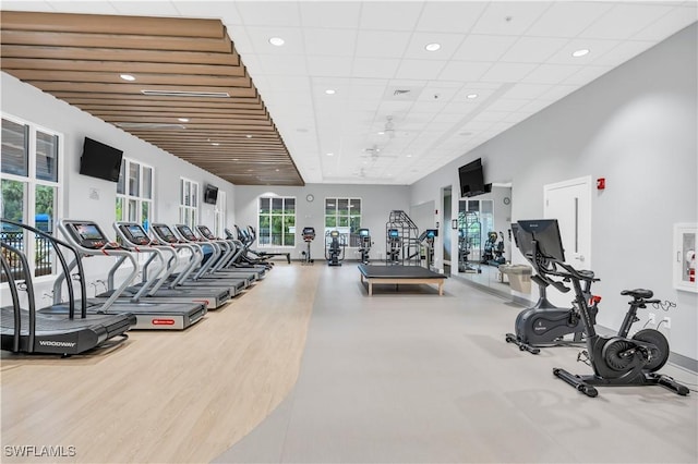 workout area with a drop ceiling and hardwood / wood-style floors