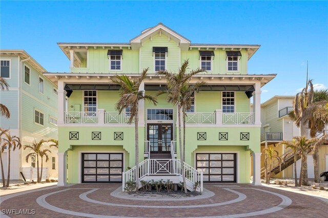 view of front of home with a garage and french doors