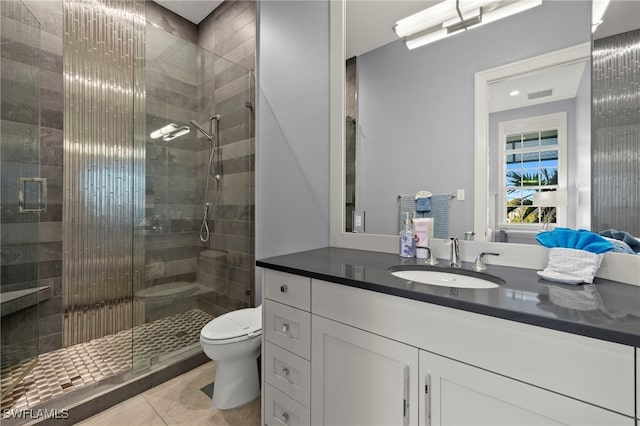 bathroom with vanity, toilet, an enclosed shower, and tile patterned flooring