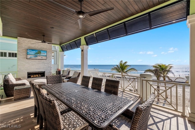 view of patio / terrace featuring ceiling fan and a fireplace