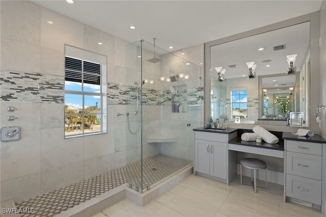 bathroom featuring vanity and a shower with shower door