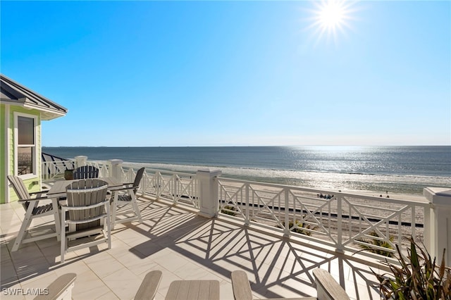 exterior space featuring a beach view and a water view