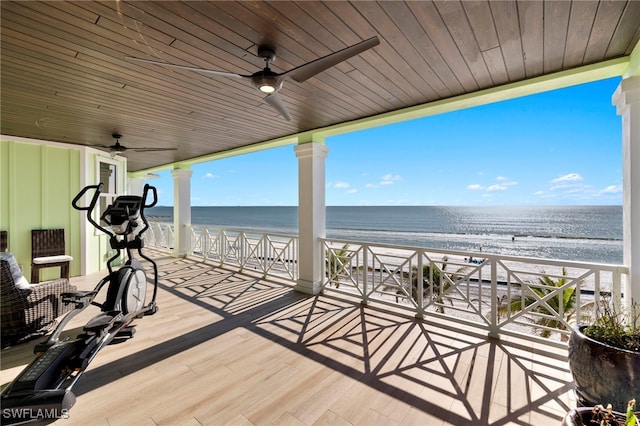 exterior space with a water view, ceiling fan, and a view of the beach