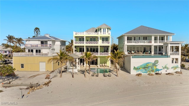 rear view of property featuring a balcony and a patio area