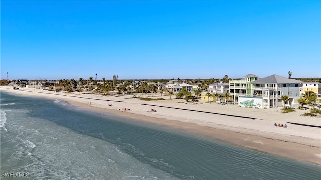 exterior space with a water view and a beach view