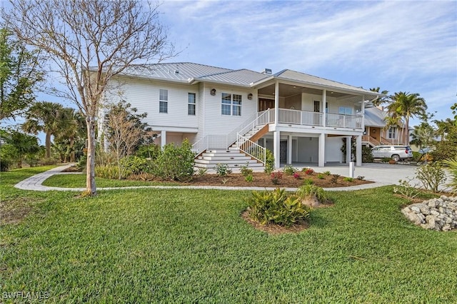 view of front of house with covered porch and a front yard