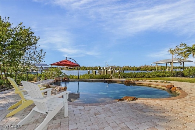 view of pool with a patio area and a water view