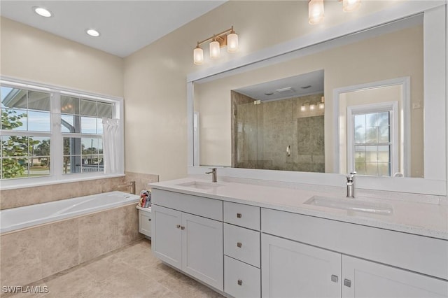 bathroom with tile patterned floors, a wealth of natural light, vanity, and shower with separate bathtub