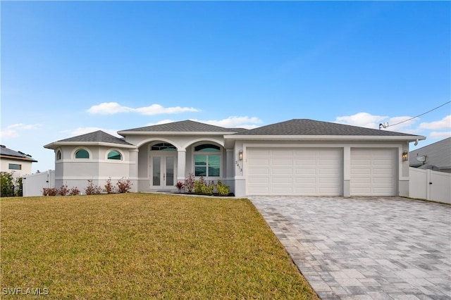 view of front of home with french doors, decorative driveway, and stucco siding