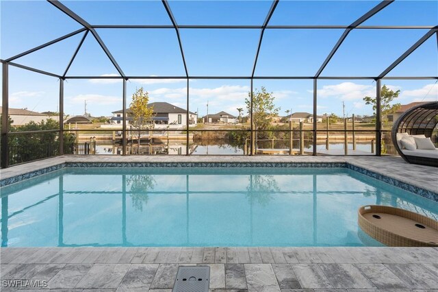 pool featuring a water view, glass enclosure, a residential view, and a patio