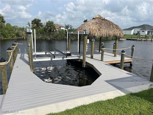 dock area with a water view and boat lift