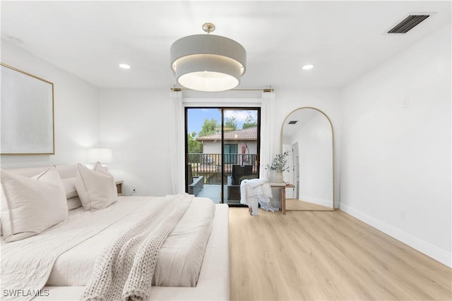 bedroom with light hardwood / wood-style flooring and access to exterior