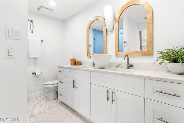 bathroom featuring vanity and toilet