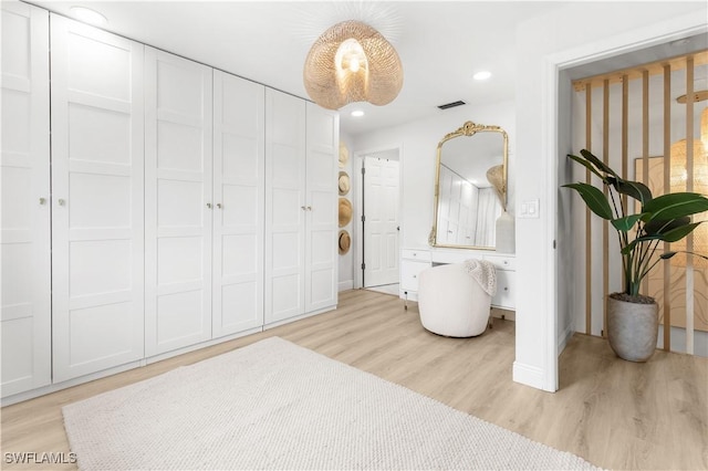 bedroom with a closet and light wood-type flooring