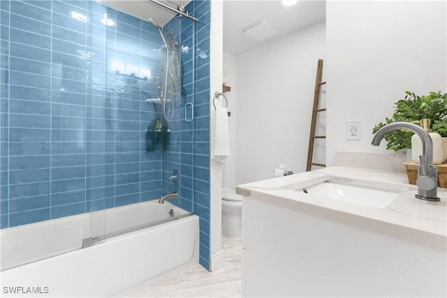 full bathroom featuring toilet, vanity, and bath / shower combo with glass door