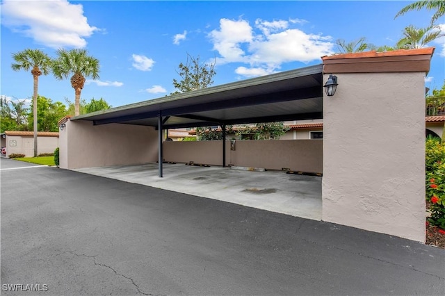 view of vehicle parking with a carport