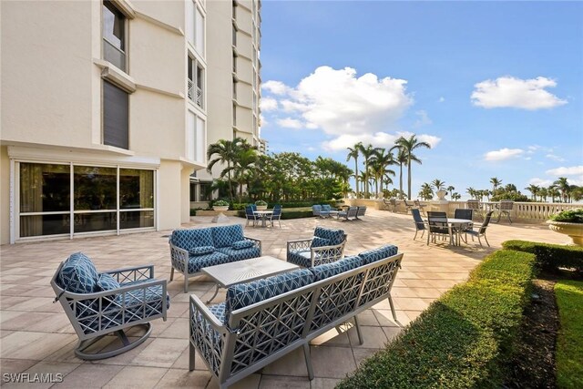 4021 Gulf Shore Blvd N Unit V-16, Naples, FL 34103 - view of patio featuring an outdoor living space and outdoor dining space