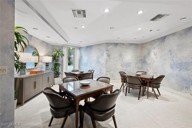 dining area featuring crown molding and light carpet