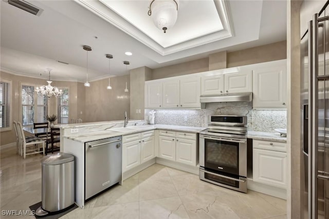 kitchen featuring white cabinetry, sink, pendant lighting, and appliances with stainless steel finishes