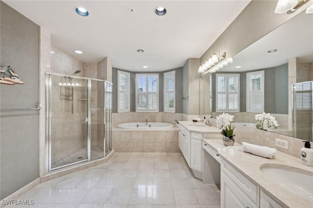 bathroom featuring tile patterned floors, vanity, and shower with separate bathtub