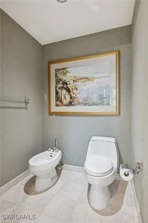 bathroom with a bidet and toilet