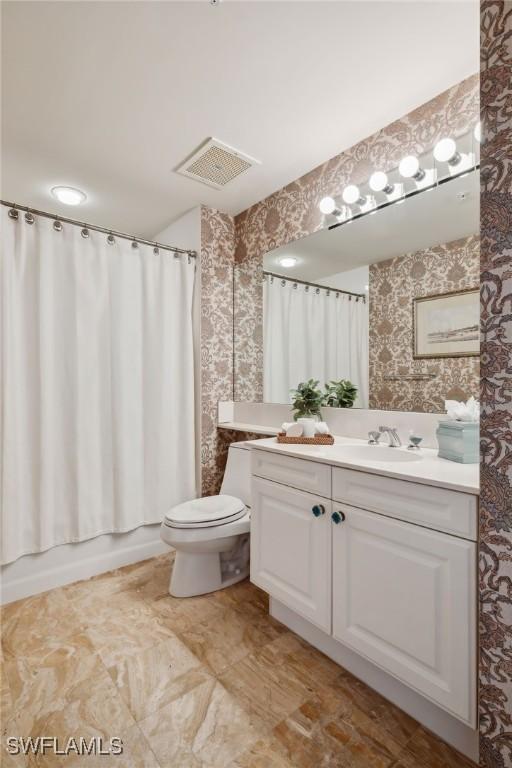 4021 Gulf Shore Blvd N Unit V-16, Naples, FL 34103 - bathroom featuring vanity, toilet, and wallpapered walls