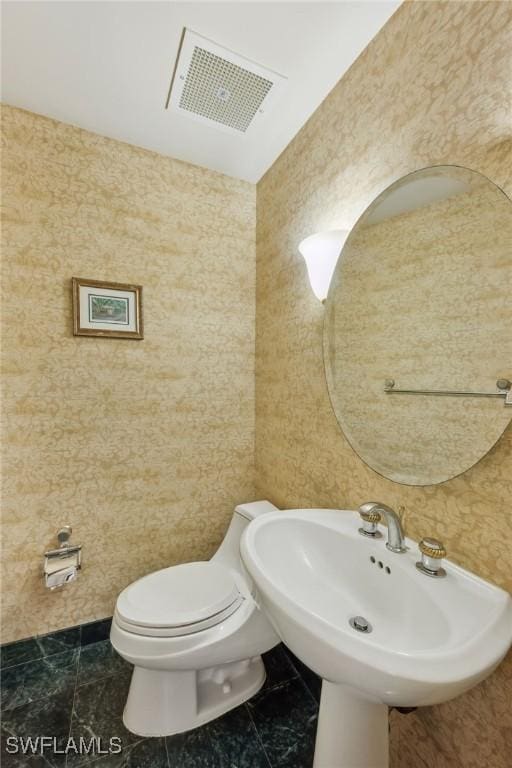 bathroom featuring sink and toilet